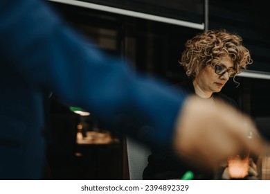 Diverse business team collaborating on projects and analyzing reports for financial growth in a creative office. Working late night and meeting deadlines with determination. - Powered by Shutterstock