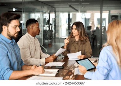 Diverse business team people having discussion at office meeting. International professional executives board group working on corporate financial strategy sitting at conference table and talking. - Powered by Shutterstock