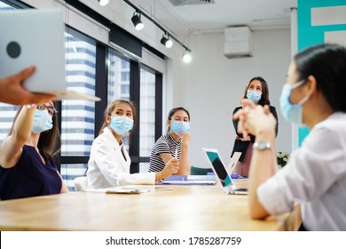 diverse business worker discuss and meeting while Wearing Medical Mask as protection from corona virus. New normal office working. Group of multiethnic people in business reopen. flu prevent healthy