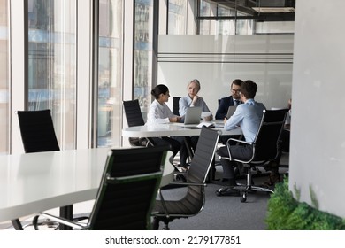 Diverse Busy Business Group Meeting At Table, Working On Project Together, Discussing Startup, Negotiating, Brainstorming In Modern Company Office, Co-working Space, Wide Shot