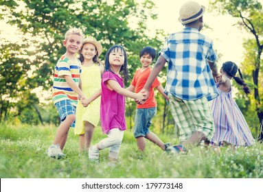 Diverse Children Holding Hands And Dancing In The Park