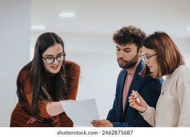 Diverse colleagues collaborate on business growth, analyzing reports and brainstorming strategies. Late nights, extra hours, and a productive workshop ensure success. - Powered by Shutterstock