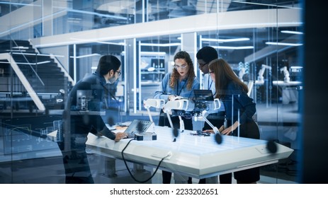 Diverse Colleagues Work in Industrial Robotics Factory, Experimenting With a Mobile Robot Prototype. Scientists Use Computers to Program the Robot Dog Before Development Testing. - Shutterstock ID 2233202651