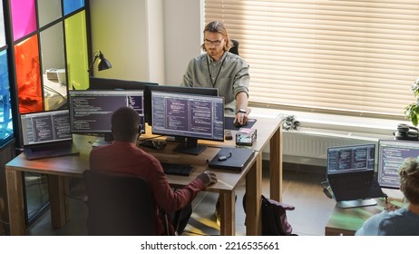 Diverse Colleagues Writing Code on Desktop Computers With Professional Multiple Monitors Setup. Software Development Team Working on Software as a Service Platform For Business Clients. - Shutterstock ID 2216535661