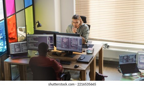 Diverse Colleagues Writing Code On Desktop Computers With Professional Multiple Monitors Setup. Software Development Department Working On Software As A Service Platform For Business Clients.