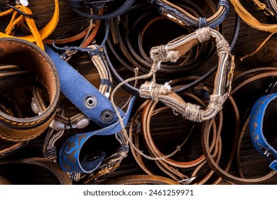 a diverse collection of handmade leather bracelets, featuring an array of designs, highlighting intricate craftsmanship and the natural beauty of leather, perfect for a fashion-forward audience. - Powered by Shutterstock