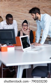 Diverse College Students Using Laptop And Talking, Learning Exchanging Ideas