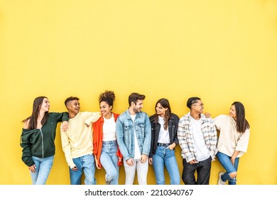 Diverse Community Of Young People Smiling Together On A Yellow Wall Background - Multiracial College Students Having Fun Laughing Outside - Youth Culture Concept