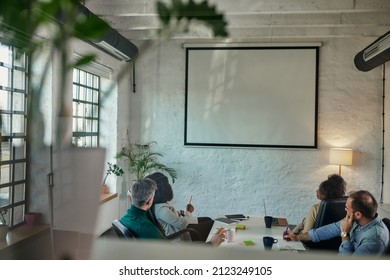 Diverse Company Employees Having Online Business Conference Video Call On Tv Screen Monitor In Board Meeting Room. Video Conference Presentation, Global Virtual Group Corporate Training Concept.