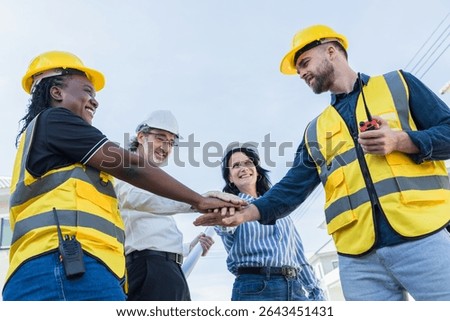 Diverse Construction engineer profession workers people join hands, Group of multiethnic company employees. The concept of unity, partnership and teamwork.