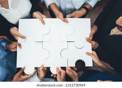 Diverse corporate officer workers collaborate in office, connecting puzzle pieces to represent partnership and teamwork. Unity and synergy in business concept by merging jigsaw puzzle. Concord - Shutterstock ID 2312730969