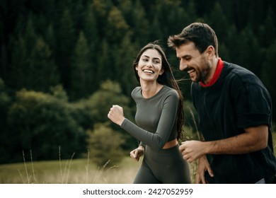 Diverse couple catching their breath after a mountain run - Powered by Shutterstock