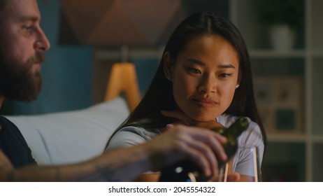 Diverse Couple Drinking Wine In Living Room