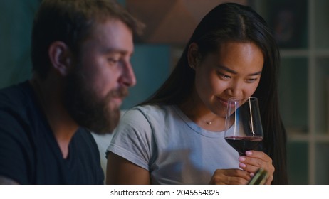 Diverse Couple Drinking Wine In Living Room