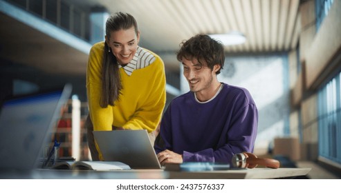 Diverse Couple of Friends and Classmates Working on a Collaborative Team Project in an Academic Library. Young Multiethnic Students Using Laptop Computer, Discussing Upcoming Lecture Topics - Powered by Shutterstock