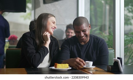 Diverse couple interaction seated at coffee shop. Two people in conversation at cafe restaurant - Shutterstock ID 2208309943