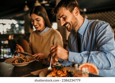 A diverse couple sharing a meal in a cozy cafe - Powered by Shutterstock