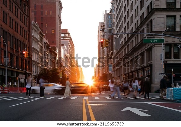 Diverse crowd of women and\
men walking across a busy intersection on 5th Avenue in New York\
City NYC