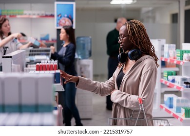 Diverse Customers Looking At Shelves Full With Pharmaceutical Drugs, Buying Health Care Products During Medication Shopping In Pharmacy. Client Looking At Supplements Leaflet, Medicine Support