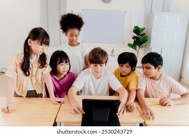 Diverse elementary students collaborate on digital tablet in modern classroom. Multicultural group engages in interactive learning, showcasing inclusive education and technological integration - Powered by Shutterstock