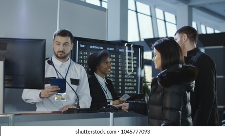 Diverse Employees Of Airport Checking Passports And Biometric Data Working With Passengers.