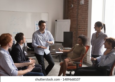 Diverse employees brainstorm share ideas at casual office meeting in coworking workspace, multiracial colleagues talk discuss projects together cooperating at informal briefing. Collaboration concept - Shutterstock ID 1489668107