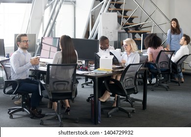 Diverse Employees Business People Office Workers Having Busy Workday In Coworking Open Space Modern Room Interior, Sitting At Shared Desks Discuss, Work Together, Teamwork Assistance Mentoring Concept