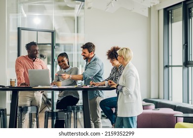 Diverse employees gathered in the office having fun during brainstorming while discussing new ideas for their new project. Multiracial coworkers gather in boardroom discuss ideas in group at briefing.