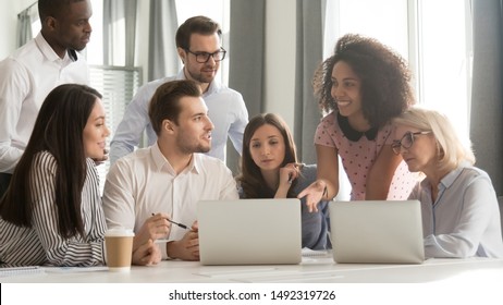 Diverse employees team discussing online project at briefing, listening to mixed race businesswoman sharing startup ideas, using laptop at office meeting, teamwork concept, horizontal photo - Shutterstock ID 1492319726