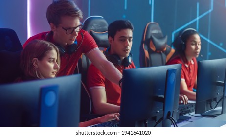 Diverse Esport Team of Pro Gamers Play in Video Game on a Championship, Talking Using Headsets, Trainer Explains Strategy. Stylish Neon Cyber Games Arena. Online Tournament Event - Shutterstock ID 1941641020