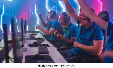 Diverse Esport Team of Pro Gamers Play in Computer Video Game and Win Championship, Celebrate with YES Gestures. Stylish Design Cyber Games Arena. Online Streaming of Tournament. Side View - Shutterstock ID 1941641098