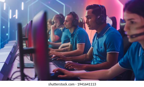 Diverse Esport Team Of Pro Gamers Playing In Video Game On World Championship, Use Headsets To Talk. Stylish Neon Cyber Games Arena. Online Broadcasting Of Tournament Event