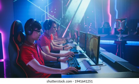 Diverse Esport Team Of Pro Gamers Play In Mock-up FPS Shooter Video Game On A Championship. Stylish Neon Cyber Games Arena. Online Broadcasting Of Tournament Event.