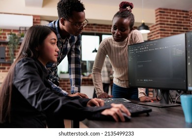 Diverse ethical hacking group defending database system by developing advanced firewall mechanism. Informatic security company employees optimizing mainframe processing methods. - Shutterstock ID 2135499233