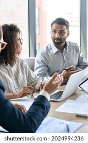 Diverse executive business team group discuss project at boardroom meeting table. Multiracial team negotiating developing international corporation business plan doing analysis in office. Vertical. - Shutterstock ID 2024994236