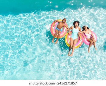 Diverse family enjoy a pool day, with copy space. They float on colorful rings, capturing the essence of summer fun. - Powered by Shutterstock