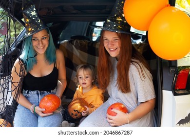 Diverse Family Friends Celebrating Halloween In Car Trunk Outdoors