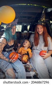 Diverse Family Friends Celebrating Halloween In Car Trunk Outdoors