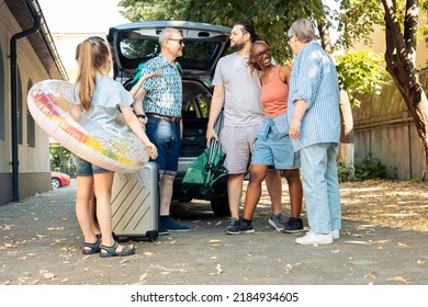 Diverse Family And Friends Travelling On Vacation At Seaside, Going By Car With Luggage And Suitcase. Child, Parents And Grandparents Leaving On Summer Holiday Trip With Baggage And Inflatable.