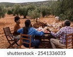 Diverse farmers pray before sharing a meal in an olive grove, embodying unity and togetherness. Expressing gratitude and hope, they celebrate community and tradition