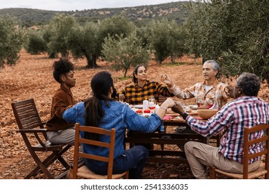 Diverse farmers pray before sharing a meal in an olive grove, embodying unity and togetherness. Expressing gratitude and hope, they celebrate community and tradition - Powered by Shutterstock