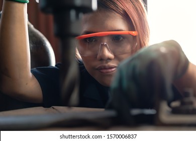 Diverse Female Certified Industrial Engineer Operating Factory Drill Machinery - Engineering Student Concentrating On Production Drilling For Manufacturing Business - Training And Learning Concept