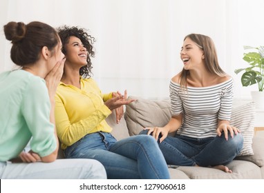 Diverse female friends talking, gossiping in the living room at home - Powered by Shutterstock