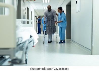 Diverse female healthcare worker helping african american senior male patient use walking frame. Hospital, medical and healthcare services, copy space. - Powered by Shutterstock