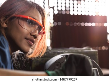 Diverse Female Mechanical Engineer Operating Heavy Industrial Machinery - Dark Skin Asian Woman Working In Engineering Workshop Wearing Safety Glasses - Diversity, Factory And Workplace Concept