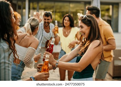 Diverse friends add to the excitement as they join in dancing at the villa pool party - Powered by Shutterstock