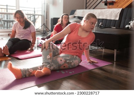 Diverse friends doing yoga at home together