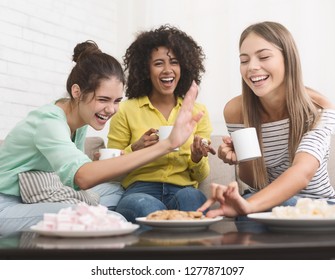 Diverse Friends Drinking Coffee, Eating Cookies And Laughing At Home