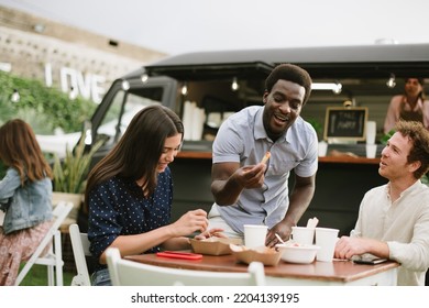 Diverse Friends Eating Near Food Truck