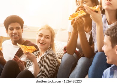 Diverse Friends Eating Pizza And Talking At Home Party, Spending Time Together